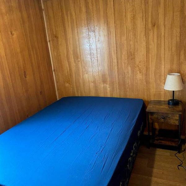 Yogi Bear cabin interior bed, nightstand, and lamp
