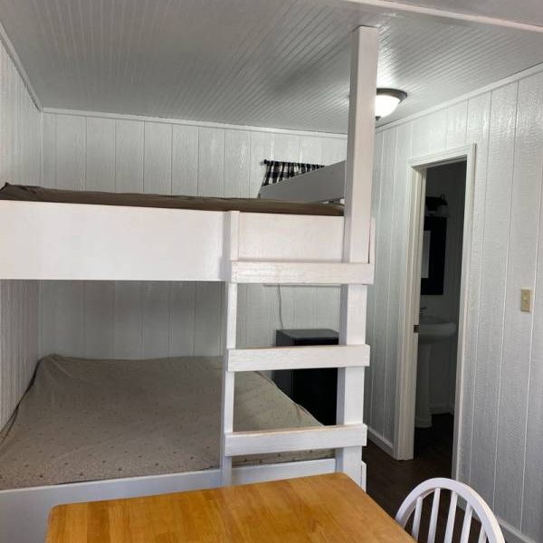 Boo Boo cabin interior with bunk beds, mini-fridge, dining area, and bathroom