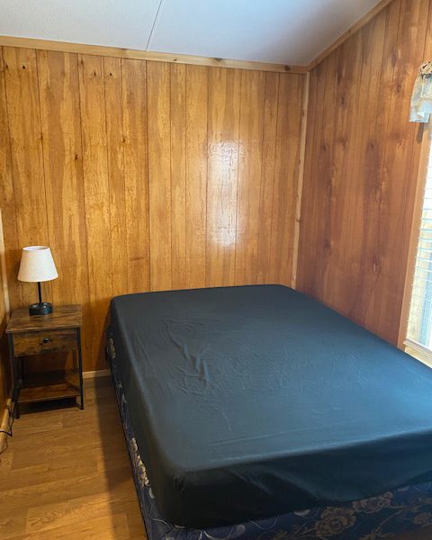 Ranger Smith cabin interior bedroom with bed and nightstand